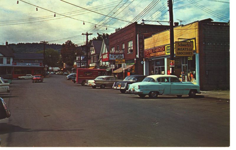 Main Street in Livingston Manor in 1958 with classic cars parked along the road